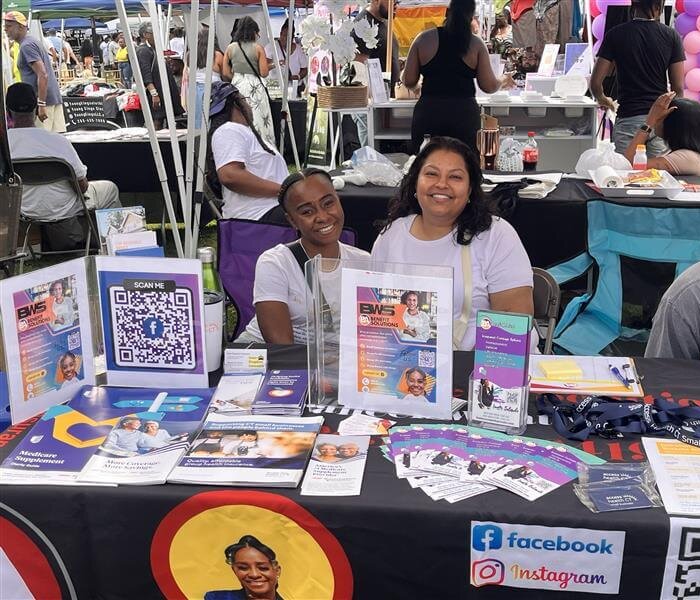 Inesta Belardo in the Black Wall Street Festival Booth with her Agent Partner giving services of insurance in the festival event