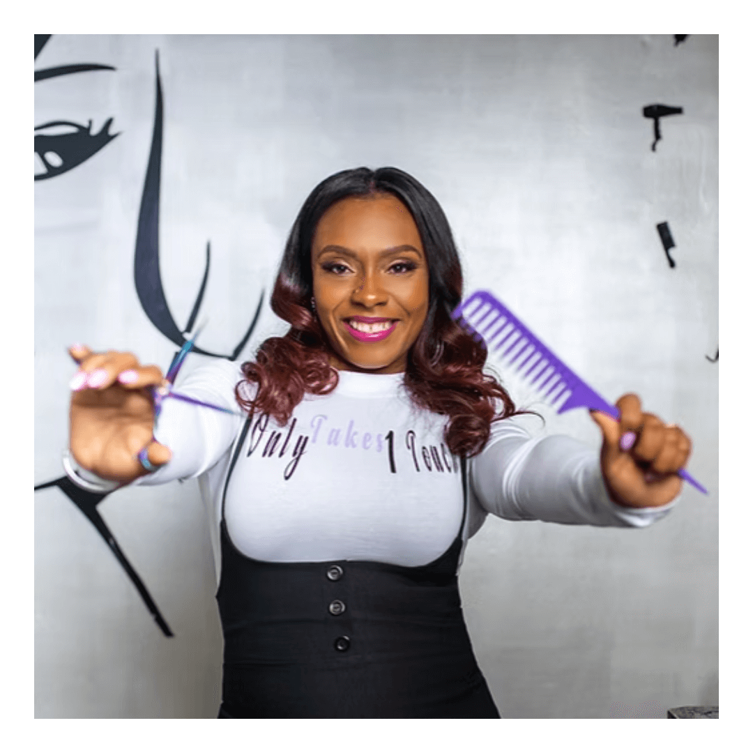 A hairstylist holding a scissor and a comb ready to serve her new customer