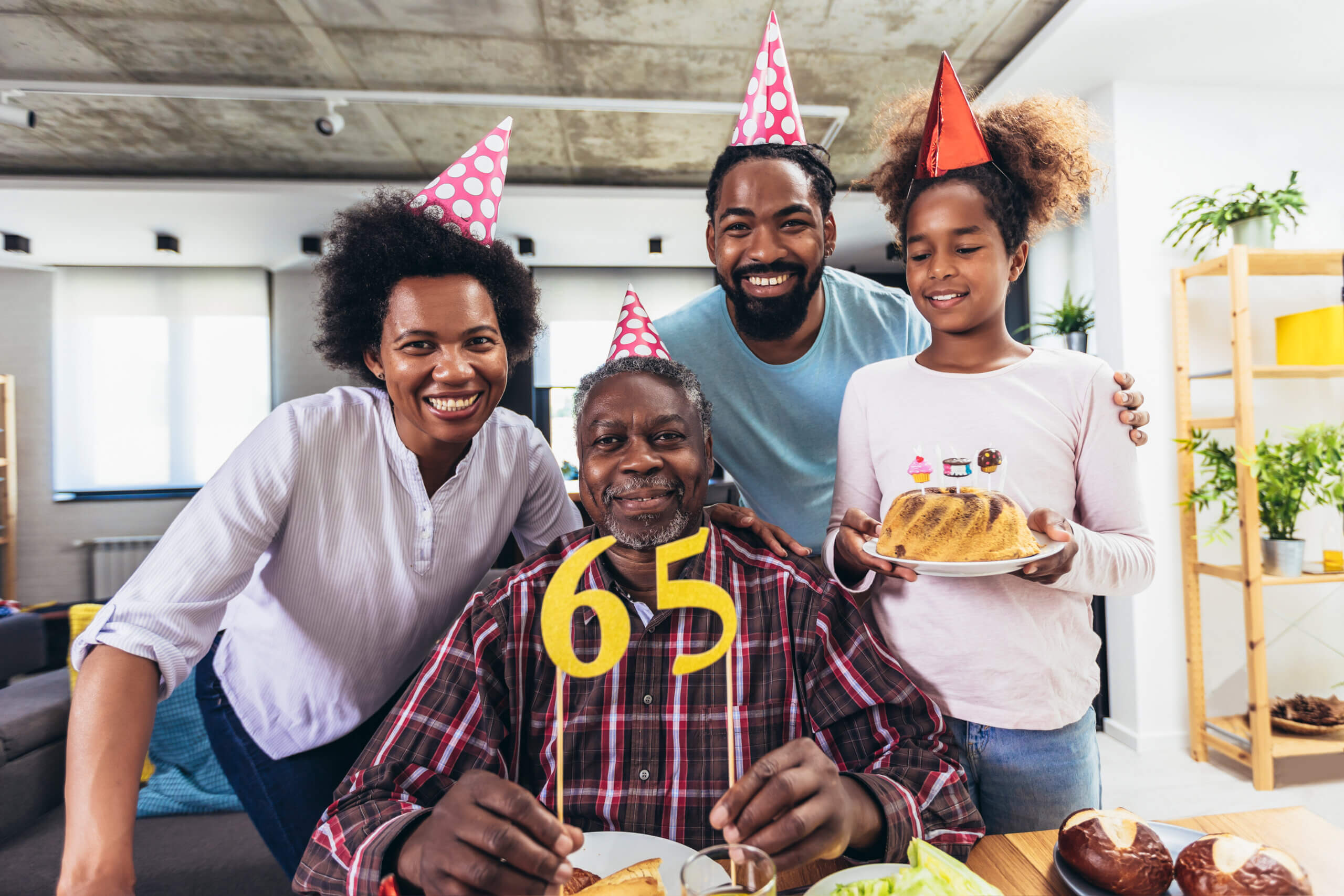 African American family celebrating their father's 65th birthday and now eligible for Medicare and Medicare Advantage
