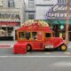 Food truck selling popcorn in the street near a cinema