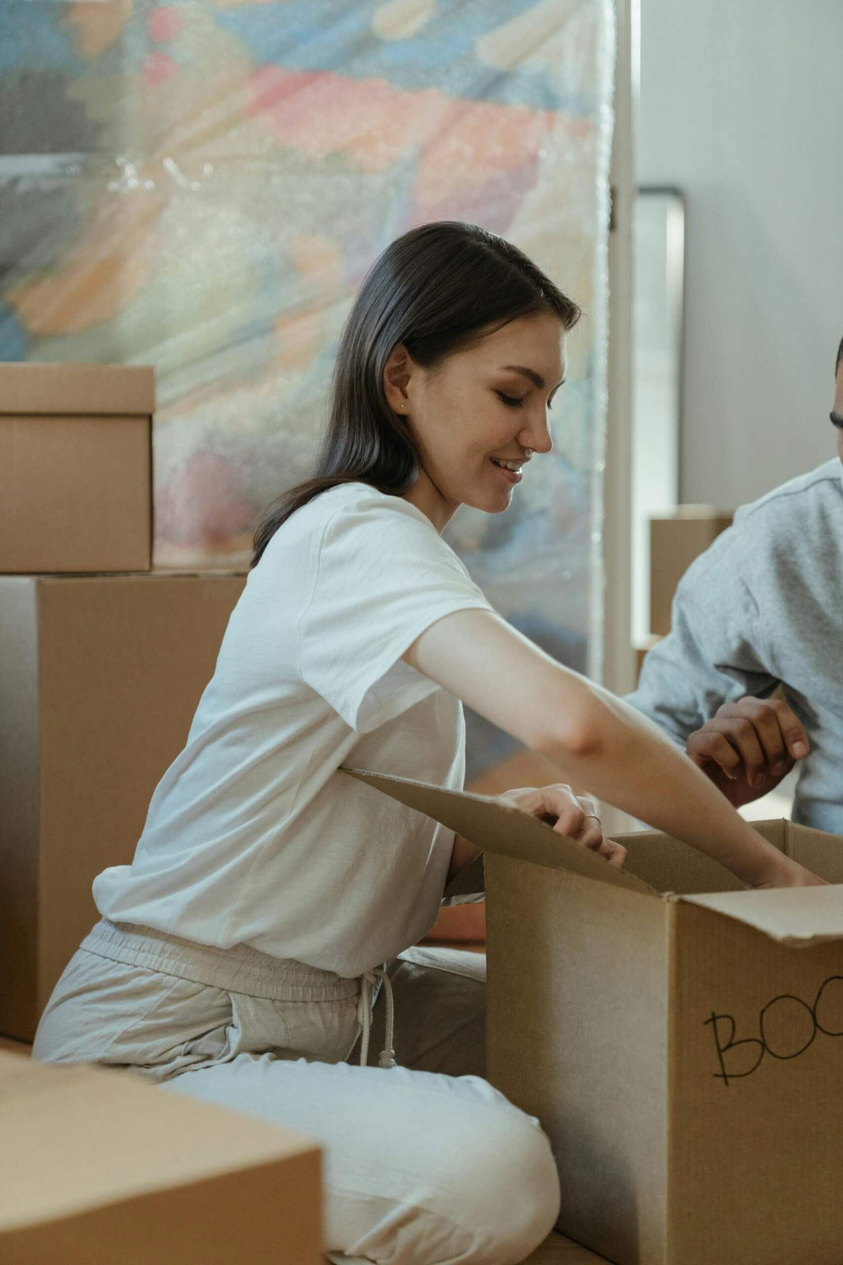 A woman unloading her things for her rent apartment
